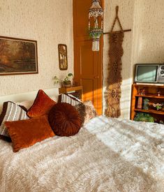 a bedroom with a bed, dresser and television