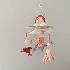 a mobile with an octopus, whale, dolphin and rainbow on it's sides