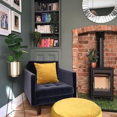 a living room filled with furniture and a fire place in front of a brick wall