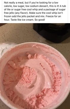 a bowl filled with pink ice cream sitting on top of a counter