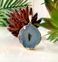 Unique 24k gold-edged teal geode pendant featuring a shimmering crystallized quartz center. 14k Gold-filled Chain Pendant: 1 1/4" x 1 1/4" 11" Long Luxury Unique Turquoise Pendant Necklace, Spiritual Turquoise Gemstone Necklace With Oval Pendant, Geode Pendant Necklace, Green Geode, Teal Necklace, Spiritual Larimar Pendant Jewelry, Spiritual One-of-a-kind Turquoise Pendant Necklace, Blue Geode, Geode Necklace