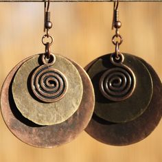 "Boho Earrings Bohemian Earrings Copper Earrings Large Boho Jewelry Dangle Earrings Bohemian jewelry Ethnic Rustic Earrings Gift For women Color :  Red Copper  swirl charm (Lead,Cadmium and Nickel Free ) Size: 13.5mm wide,18mm long Finish : Antiqued Copper disc round hammered by hand ( 1\"1/4, 32mm ) and antique brass coin drop charm ( 20 mm ) Length : 2\"1/4 including the antiqued brass ear wire Hand hammered by myself. Mixed metal Earrings : https://www.etsy.com/shop/NtikArtJewelry?section_id=16062194 Matching Necklace : https://www.etsy.com/listing/1316667192/large-boho-necklace-pendant-bohemian?click_key=33820d2355d0dc4604594266ea1cb3465a7dd416%3A1316667192&click_sum=9163d185&ref=shop_home_active_8&sts=1 To visit my shop : https://www.etsy.com/shop/NtikArtJewelry I usually ship between Rustic Earrings, Mixed Metal Earrings, Earrings Bohemian, Earrings Inspiration, Earrings Large, Ethnic Earrings, Bohemian Earrings, Fort Collins, Large Earrings