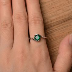 It is a lab emerald ring. The main stone is 7mm*7mm round cut, weight about 1.3 carats. The basic metal is sterling silver and plated with rhodium. To change the metal to a solid gold (white/rose) or platinum is also available, please ask for a quotation if you want. You can also go to my shop Home for more elegant rings: https://www.etsy.com/shop/godjewelry?ref=hdr_shop_menu More rings: https://www.etsy.com/shop/godjewelry?ref=l2-shop-header-avatar Customization is always welcome and please fee Emerald Solitaire Birthstone Promise Ring, Promise Emerald Ring May Birthstone Round Cut, Promise Emerald Ring With Round Cut For May Birthstone, Emerald Round Cut Promise Ring Birthstone, May Birthstone Ring For Promise, Green Emerald Promise Ring, Solitaire Diamond May Birthstone Promise Ring, Solitaire Diamond Promise Ring For May Birthstone, Emerald Solitaire Promise Ring