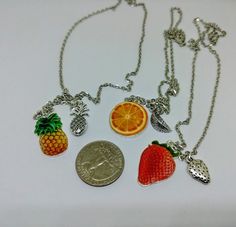 "This listing is for one fruit necklace. Your choice of Strawberry, Orange, or Pineapple! These necklaces are great for those summer beach vibes all year round. The main center charm is silver plated photo realistic and about the size of a quarter (give or tank) and the secondary charm varies but is smaller than the main, colorful charm. To see an example of how these lay look at the last potato quality photo! I keep the main fruit free sliding but I lock the smaller fruit charm for a layered bu Casual Jewelry With Fruit Design For Gifts, Silver Charm Necklace For Summer Gift, Silver Charm Necklaces For Summer Gifts, Casual Fruit Design Jewelry Gift, Summer Casual Jewelry With Fruit Design, Casual Summer Jewelry With Fruit Design, Silver Jewelry With Fruit Design For Gifts, Fruit Necklace Beads, Cute Multicolor Fruit Design Jewelry