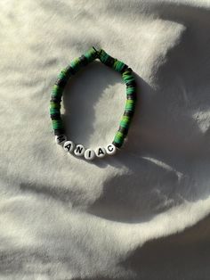 Stray Kids bracelet! Maniac ver.  Black and green beads Other bead colors available! Fully customizable!  Bracelets will come with three freebies (two stickers and a random lomo card)! Follow us on instagram! @z_c_creations Handmade Casual Name Bracelet With Round Beads, Stray Kids Beaded Bracelet, Personalized Green Bracelets As Gifts, Adjustable Green Bracelets With Letter Beads, Handmade Green Bracelets For Everyday Wear, Personalized Green Name Bracelet As Gift, Personalized Green Name Bracelet For Gift, Handmade Green Bracelet For Everyday Wear, Green Letter Beads Bracelets For Friendship