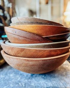 several wooden bowls stacked on top of each other