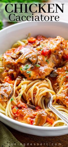 a white bowl filled with chicken cacciatore and pasta on top of a wooden table