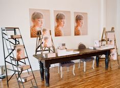 a table with chairs and pictures on the wall