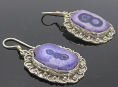 "925 Sterling Silver - Vintage Purple Agate Swirl Border Dangle Earrings - EG2986  925 Sterling Silver - Vintage Purple Agate Swirl Border Dangle Earrings - EG2986  Jewelry Type:         Earrings   Metal Type:            925 Silver   Metal Size:             1.5\"  Stone Type:            Agate   Condition:              N/A  Jewelry Weight:     10.7 Grams  PLEASE NOTE: THIS ITEM IS PRE-OWNED. ALTHOUGH MOST ITEMS ARE IN VERY GOOD CONDITION, SOME MAY NEED CLEANING AND/OR MINOR REPAIRS. WE MAKE A VER Elegant Silver Agate Earrings, Silver Agate Gemstone Earrings, Pierced Silver Agate Jewelry, Silver Agate Jewelry, Swirl Border, Purple Agate, Earrings Metal, Vintage Purple, Antique Rings