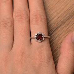 It is natural garnet ring, the main stone is about 7mm*7mm, round cut, weight about 1.68 carats. The basic metal is sterling silver and plated with rhodium. To change the metal to a solid gold (white/rose) or platinum is also available, please ask for a quotation if you want. You can also go to my shop Home for more elegant rings: https://www.etsy.com/shop/godjewelry?ref=hdr_shop_menu Natural garnet is January birthstone. More natural garnet rings: https://www.etsy.com/shop/godjewelry?ref=seller Garnet Birthstone Ring With Prong Setting, Garnet Birthstone Ring For Anniversary, Anniversary Garnet Birthstone Ring, Round Ruby Flower Promise Ring, Wedding Silver Garnet Birthstone Ring, Classic Round Gemstone Flower Ring, Anniversary Ruby Flower Ring, Round Gemstone Flower Promise Ring, Anniversary Gemstone Flower Ring