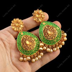 Our ears are the most eye-catching attraction of face. Earrings are the one of the major body adornment people observe when looking at you. We make your entire look stand out just by decorating your ears with our unique Kundan earrings in Indian Style. The Earrings we make is of the highest quality, both materials & craftsmanship wise. Treat yourself to it. It'll be your best friend. ❖ ❖ ❖ Features: ❖ An Indian styled dainty Kundan Chandelier Earrings. ❖ Made from fine Quality Brass with Gold Platting. ❖ Ready to be given as a gift. ❖ Easy and Convenient way to Wear. ❖ It looks prettier than the images. Direct Images on hand is also attached. Size of Earrings & Other Details: ❖ Item Code:-  ❖ Length:- 75mm approx ❖ Width:- 35mm approx ❖ Material:- Fine Quality Brass with Gold Platting ❖ Qu Green Bridal Earrings With Latkans For Festivals, Green Chandelier Earrings For Diwali Gift, Green Dangle Bridal Earrings For Festivals, Green Latkans Earrings For Diwali, Traditional Green Earrings For Party, Ornate Jhumkas For Festivals With Pierced Ears, Green Temple Jewelry Style Chandelier Earrings As Gift, Green Bollywood Style Chandelier Earrings As Gift, Green Temple Jewelry Chandelier Earrings As Gift