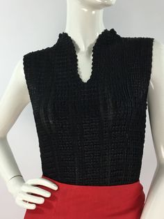 "Vintage black Nicola sleeveless top, size equivalent to medium/large  Measurements:  Shoulder outer seam-seam 13\"/bust 15\"-24\"/length 22\" Material will stretch several inches  Mannequin measurements:  5'8\", bust 34\", waist 25\", hip 33\" Please note that vintage clothing sizes can vary greatly.  The Measurements provided  are approximate and are taken lying flat.  I suggest taking a similar garment from your wardrobe and measure it while lying flat.  This way you can compare measurements. Vintage Stretch V-neck Top, Black V-neck Vest For Night Out, Retro V-neck Fitted Vest, Black Sleeveless Vest Top, Fitted Black Knit Tank Top, Black Retro Sleeveless Tank Top, Retro Black Tank Top, Chic Black Sleeveless Top, Fitted Black Tank Top