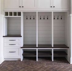 a white bench and some shelves in a room