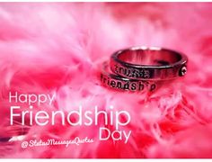 two wedding rings sitting on pink feathers with the words happy friends day written on them