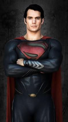 a man in a superman costume standing with his arms crossed