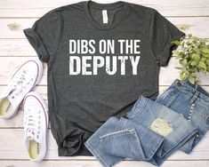 Dibs on the Deputy Shirt Well, let's say goodbye to all this boring apparel... The GodBlessThisDesign team creates custom clothes with great designs to suit all tastes. Our unique and blessed designs are a blast fit for every occasion and always a perfect fit... We combine our beautiful designs with high quality apparel like no one has ever done before. There's nothing worse than being charmed by a nice design and then finding that the apparel with that design looks like an old cheap and mediocre quality apparel. All right, then ... we got you covered. You are absolutely going to love our dynamic duo of comfortable AND cute apparel. A B O U T - T H I S - A P P A R E L Available in : T-shirt,  Women Racerback Tank,  Long Sleeve T-shirt, Sweatshirt Available in size : XS, S, M, L, XL, 2XL, 3 Horse Shirt, Sarcastic Shirts, Mama Shirts, Concert Shirts, Bella Canvas Tees, Band Shirts, Christian Shirts, Mom Shirts, Unisex Shirt