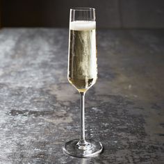 a glass filled with champagne sitting on top of a table