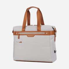 a white and tan bag with brown straps