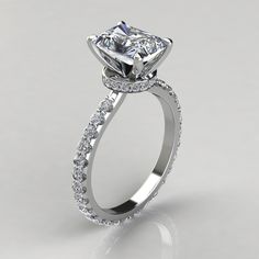 a diamond engagement ring on a white background