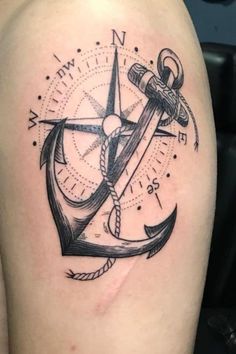 an anchor and compass tattoo on the thigh