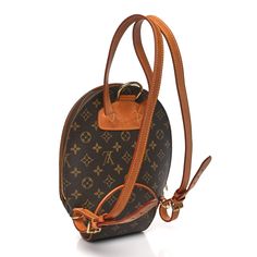 This is an authentic LOUIS VUITTON Monogram Ellipse Sac a Dos Backpack. This petite backpack is crafted of classic Louis Vuitton monogram coated canvas with complimentary signature vachetta natural cowhide for structure and style. There is a brass 3/4 wrap around zipper that opens to an interior of resistant, cocoa colored alcantara fabric with a patch pocket and a D ring. D Ring, Authentic Louis Vuitton, Wrap Around, Patch Pocket, Louis Vuitton Monogram, Cocoa, Louis Vuitton, Monogram, Backpacks