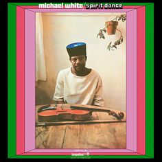 a man sitting at a table with a violin in front of him and the words michael white spirit dance on it