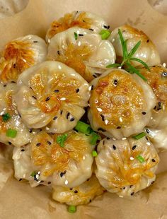 some dumplings with sesame seeds and seasoning on top