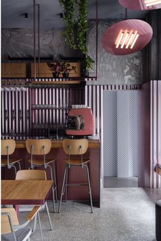 the interior of a restaurant with striped walls and wooden tables, chairs, and benches