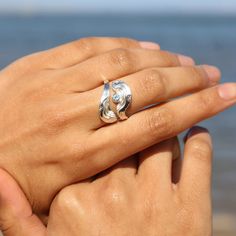 The Serenity Collection draws inspiration from the serene beauty of the ocean and its shores. Our adjustable Sanctuary ring has been carefully crafted by Balinese silversmiths from environmentally friendly recycled 925 sterling silver. The design features a beautiful light blue Topaz gemstone, evoking the shimmering essence of water. The ring measures 20mm/ 0.79’’ in height and 22mm/ 0.87’’ in width and depth. The clever adjustable design of the ring allows it to suit the ring sizes 7.5 /P to 10 /U. Our Serenity designs arrive packaged in a beautiful complementary round gift box with a dark velvet inlay, which is ideal for gifting or storing your jewellery. Every purchase from the collection contributes to the protection of our precious ocean ecosystems and wildlife, through BoldB's suppor Round Gift Box, Round Gift Boxes, Christian Ornaments, Ocean Inspired Jewelry, Blue Topaz Gemstone, Memorial Keepsakes, Ring Sizes, Ocean Inspiration, Topaz Gemstone