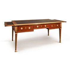 an antique desk with two drawers on one side and gold trimmings on the other