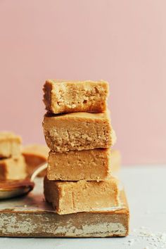 three pieces of peanut butter fudge stacked on top of each other next to a spoon