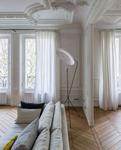 a living room with white walls and wooden floors