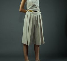 Pleated beige culottes by RailiNolvak on Etsy Pleated Culottes Outfit, Elegant Spring Pleated Skirt With Belt, Beige Wide Leg Bottoms With Pleated Waist, Chic Beige Wide-leg Culottes, Chic Summer Culottes With Belt Loops, Elegant High Waist Beige Culottes, Chic Box Pleat Bottoms For Spring, Elegant Belted Knee-length Bottoms, Chic Bottoms With Box Pleat For Spring