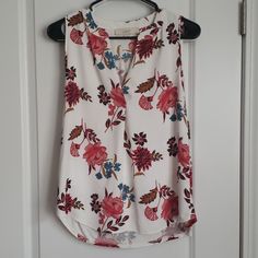 White With Red And Blue Floral Print, Sleeveless Blouse. New, Never Worn, But No Tags Red Floral Print Sleeveless Tank Top, White Sleeveless Blouse With Floral Print, White Floral Print Sleeveless Blouse, Red Floral Print Sleeveless Blouse, Blue Floral Print, Sleeveless Blouse, Printed Blouse, Blue Floral, Red And Blue