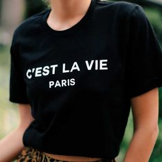 A Classic Black Graphic T-Shirt Featuring The C’est La Vie Paris Logo. As Seen On Paris + Me Website For $65! Bella + Canvas Premium 100% Cotton Tee Runs Oversized Classic Tee Shirt Sizing S - 2/4 M - 6/8 L - 10/12 Paris Landscape, Black And White Graphic Tee, Paris Graphic, Moon Graphic Tee, Paris Logo, Paris T Shirt, White Graphic Tee, Frayed Denim, Cute Skirts