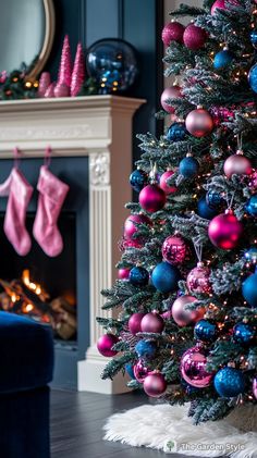 a decorated christmas tree in front of a fireplace