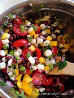 a metal bowl filled with lots of different types of vegetables and vegtables