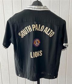 "Vintage 1960's Mr. Morts Short Sleeve Bowling Shirt.  Black in color with black and white striped trim at collar pocket tops and cuffs. Has \"South Palo Alto Lions\" on the back, w a Lions patch in the center. Has a patch on the left shoulder \"1967-1968\" ABC League Champ. 1 front pockets. Has a bowling pin on the pocket top. Size Medium.  Measures 48\" chest & 25\" length.  Great vintage condition." Black Collared Tops With Contrast Stripes, Black Shirt With Striped Collar, Streetwear Top With Striped Collar, Retro Black Camp Shirt With Camp Collar, Black Retro Shirt With Camp Collar, Retro Black Collared Shirt, Retro Collared Tops With Contrast Stripes, Vintage Black Shirt With Camp Collar, Retro Collared Camp Shirt For Streetwear