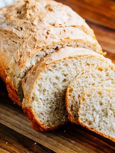 a loaf of bread sitting on top of a wooden cutting board