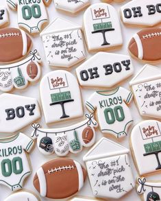 decorated cookies with footballs and other sports related items are arranged on a white surface