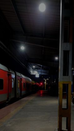 a train is parked in the station at night