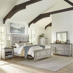 a bedroom with white walls and wooden floors