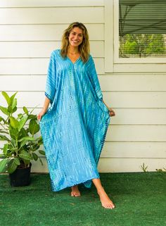 "Add a touch of unique style to your wardrobe with our Hand-Dyed Kaftan Dress! This stunning dress is made from 100% breathable and comfy rayon fabric, ensuring maximum comfort all day long. Using the traditional Shibori method, each dress is carefully hand dyed, resulting in a one-of-a- kind masterpiece. The intricate patterns and vibrant colors make this dress a true work of art. The kaftan dress comes in a versatile one size fits most (M-3XL), making it extremely comfortable for a wide range Tie Dye Natural Dye Dress For Beach Cover-up, Beach Cover-up Tie Dye Dress With Natural Dye, Tie Dye Natural Dye Dress For Beach, Bohemian Hand Dyed Blue Dress, Hand Dyed Blue Bohemian Dress, Hand Dyed V-neck Beach Dress, Blue Bohemian Dress With Natural Dye, Tie-dye V-neck Dress With Natural Dye, Blue Hand-dyed Beach Dress