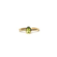 Pear Shape Peridot Ring 0.25ct / 14k Gold Peridot Engagement Ring / Solitaire Peridot Pear Shape Ring / August Peridot Ring free shipping within the USA HANDMADE AND HANDSET NATURAL PEAR SHAPE PERIDOT RING 0.25CT IN A HANDMADE BEZEL SETTING IN 14K SOLID GOLD. THE PERIDOT IS A GENUINE PEAR SHAPE PERIDOT WITH A GORGEOUS DEEP GREEN COLOR AS IT IS WITH THIS ITEM ALL MY PIECES ARE HAND MADE. THIS DELICATE AND DAINTY ENGAGEMENT RING IS MADE IN 14K YELLOW GOLD BUT I CAN ALSO MAKE IT IN 14K WHITE AND RO Yellow Gold Peridot Diamond Ring With Birthstone, Fine Jewelry Peridot Rings For May Birthstone, Yellow Gold Stackable Rings With Peridot, Yellow Gold Peridot Stackable Rings For Anniversary, Peridot Birthstone Diamond Ring Fine Jewelry, Yellow Gold Peridot Birthstone Ring, Green Pear-shaped 14k Gold Rings, Yellow Gold Peridot Stackable Rings, Yellow Gold Peridot Stackable Rings For Wedding