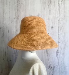 Crochet raffia hat     It is a classic accessory for every woman for sun protection, summer parties, beach and travel. It can be a good gift for a woman of any age. The hat is crocheted of natural raffia, light, elastic, the brim of the hat is reinforced with wire. The hat keeps its shape well and does not fade in the sun. The hat is soft to the touch, slightly rough. It is completely crocheted by hand. Easy to carry thanks to the foldable design. The hat matches perfectly with a summer wardrobe. Color: Straw color Size: 21 1/2 - 23 1/2 inches Field size: about 4 inches Care of the product:        It is better to dry the hat naturally, without using additional heating sources. When the raffia product dries, it returns to its original shape.        You cannot wash them in the usual way. If Lightweight Natural Straw Hat For Vacation, Natural Lightweight Straw Hat For Vacation, Vacation Straw Hat With Woven Details, Palm Leaf Straw Hat For Vacation, Natural Woven Sun Hat For Vacation, Brimmed Woven Straw Hat For Vacation, Woven Brimmed Straw Hat For Vacation, Woven Toquilla Straw Hat For Summer, Summer Woven Toquilla Straw Hat