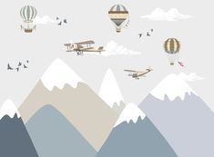 there are many hot air balloons flying in the sky with mountains and birds around them