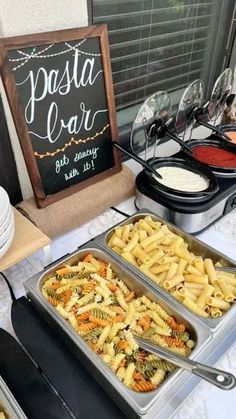 a buffet with pasta and other foods on it