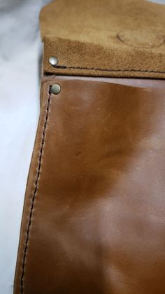 a brown leather case with stitching on it