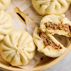 some dumplings are cut in half and placed on top of each other with one bite taken out