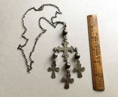 "A vintage Mexican silver cross necklace, with large Yalalag-style pendant, consisting of a central crusader-style cross with 3 smaller crosses suspended from it. The crosses are linked with large wire connectors with hollow silver beads. The casting of the central cross is a bit crude, but this gives it a nice aged look. All the parts hang and swing freely. This necklace is one of two purchased at the same time, in the late 1950s or 1960s, by a friend; she thinks it may have been at a museum sh Silver Cross Necklace, Sterling Silver Cross Necklace, Museum Shop, Wire Connectors, Small Crosses, Vintage Mexican, Sterling Silver Cross, Silver Cross, Silver Beads